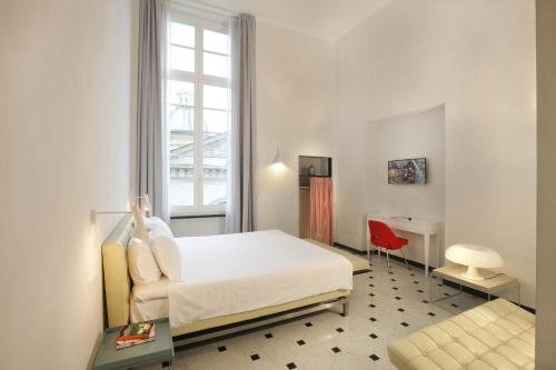 热那亚云邸酒店的一间卧室配有一张床、一张书桌和一个窗户。