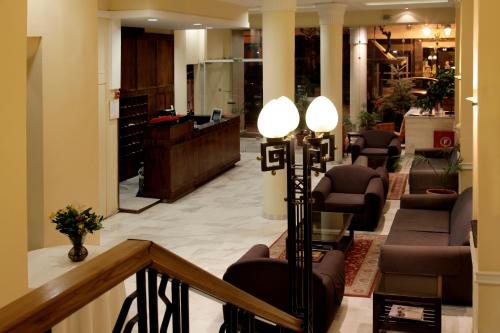 塞萨洛尼基佩拉酒店的大堂设有带椅子和书桌的等候区
