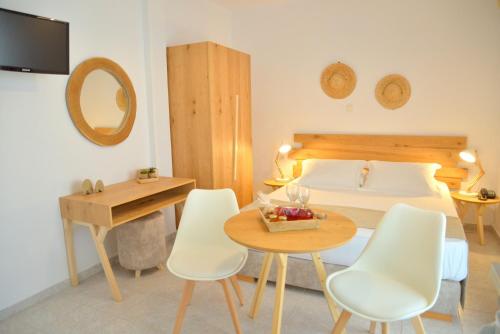 阿波罗尼亚Studios Kymata的卧室配有一张床和一张桌子及椅子
