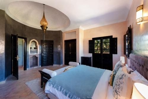 Dar Caïd Layadi马拉喀什达拉米亚别墅的一间卧室配有一张带蓝色毯子的大床