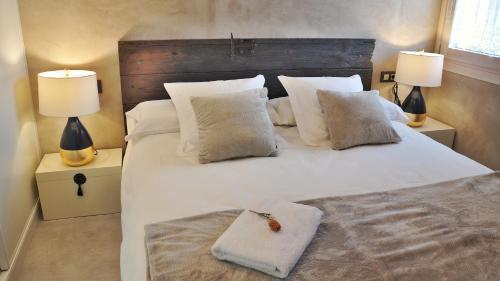 圣洛伦索-德莫鲁尼斯Casa Rural Cirerer的一间卧室配有一张带两盏灯的大型白色床。