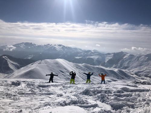 古多里RezoHut的站在雪覆盖的山顶上,四人