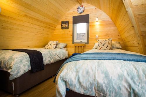 多诺赫Evelix Pods Dornoch的小木屋内一间卧室,配有两张床