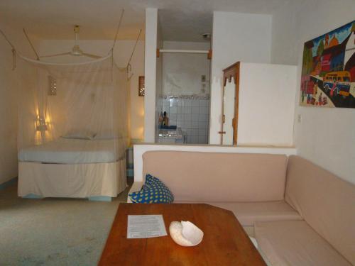 萨利波图尔科尔玛雅公寓式酒店的客厅配有沙发和1张床