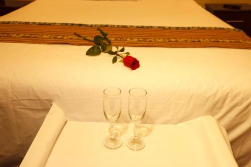 利马卡萨苏维酒店的床上桌子上放两杯酒