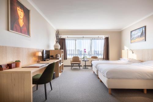 根特卡尔顿酒店的酒店客房配有两张床和一张书桌