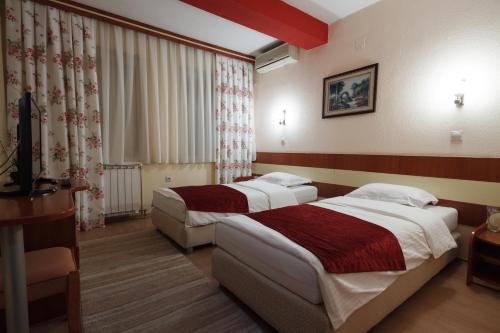斯特鲁米察伊林登酒店的一间酒店客房,房间内设有两张床