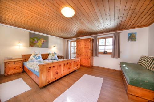 平茨高谷地霍勒尔斯巴赫Peilberghof的一间卧室配有一张床和一个沙发