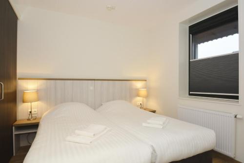 斯希蒙尼克奥赫品质住宿酒店的窗户客房内的一张白色床