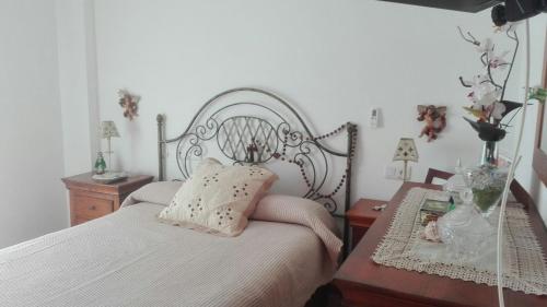 卡沃内拉斯Apartamento turístico en C/ Los Barquicos的一间带白色床和金属床头的卧室