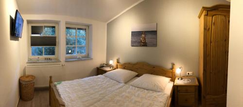 青斯特Haus Hugo的卧室配有白色的床和2扇窗户。