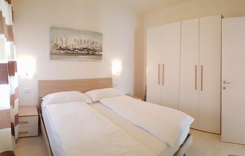 特雷莫西内Casa Palanca Lake view apartment by Gardadomusmea的白色卧室配有一张床和橱柜