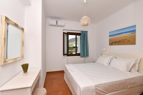 帕罗奇亚Villa Trifylia的白色的卧室设有床和窗户