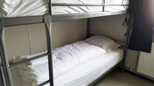 华姆斯唐吉华姆斯唐吉旅舍的两张双层床,配有白色床单和枕头