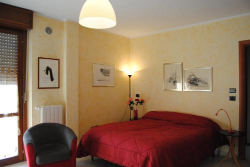 奇列B&BLeTerrazze BoutiqueHotel2-Torino的一间卧室配有红色的床和椅子