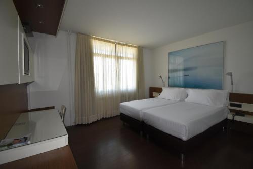 瓜尼佐Hotel Los Angeles的酒店客房设有床和窗户。