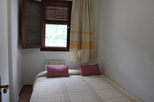 卡皮雷拉Apartamentos Rurales Rosendo: La Albahaca的窗户客房内的一张床位