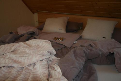 明希贝格Ferienwohnung Dieter Popp的一张未铺好的床,上面有两双眼镜