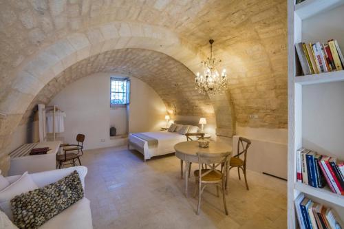 栋纳富加塔Terre di Cavalusi Relais的一间卧室和一间带一张床铺和一张桌子的客厅