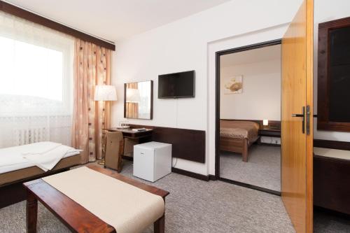 尼萨河畔亚布洛内茨莫库尔酒店 - 尼斯河畔亚布洛内茨的酒店客房,配有床和镜子