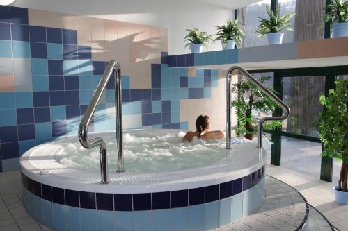 什恰夫尼察Hotel Solar的游泳池里浴缸里的女人