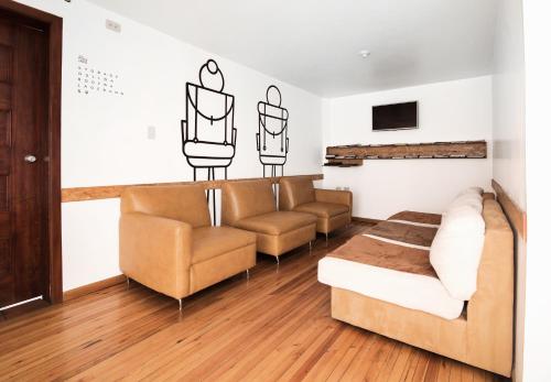 昆卡AlterNative Hostels的客厅配有两张沙发和一张沙发