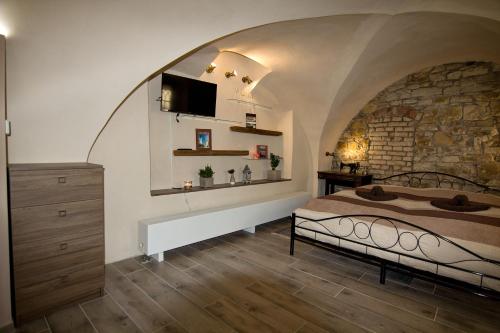 利托梅日采Apartmán U Gotického dvojčete的一间卧室设有一张床和石墙