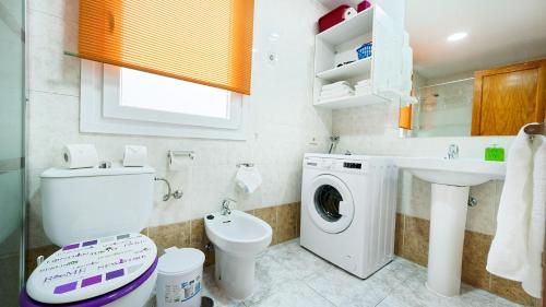 阿里纳加Armonía Beach 104的浴室配有卫生间、盥洗盆和洗衣机。