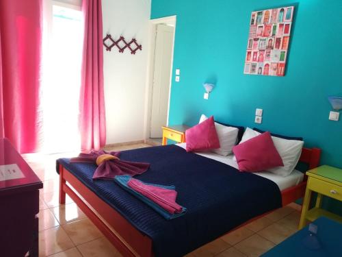 帕罗奇亚Viva Margarita的一间卧室配有一张粉红色和蓝色的墙壁。