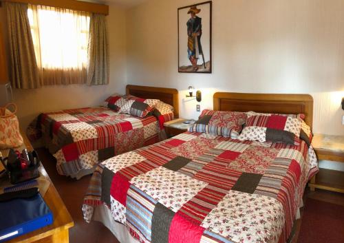 帕纳哈切尔Posada De Los Volcanes的一间酒店客房,房间内设有两张床