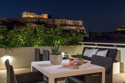 雅典卫城迪瓦尼宫殿酒店的夜晚阳台上的白色桌椅