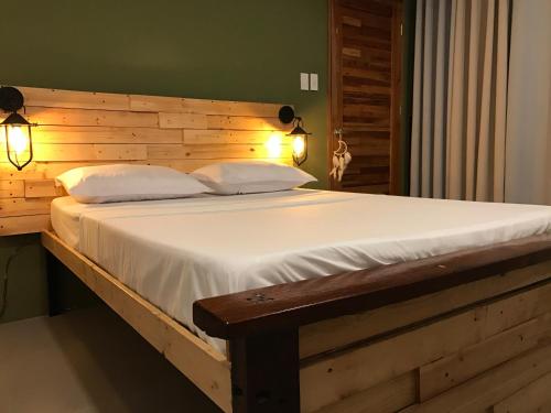 科隆Michel'inn Coron的一张带木制床头板的床和两个枕头