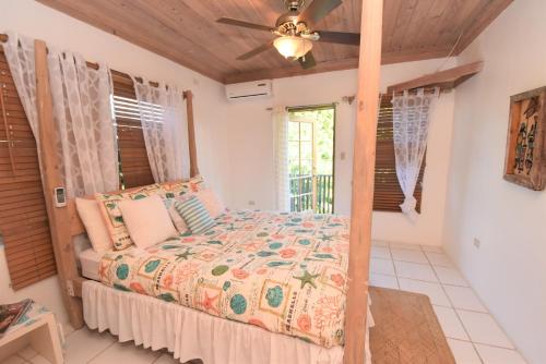 哈勃岛甜苹果公寓式酒店的一间卧室配有一张床和吊扇