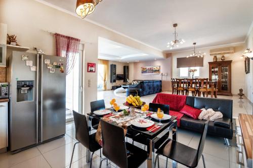 耶奥伊乌波利斯Villa Amfimala的厨房以及带桌子和沙发的客厅。