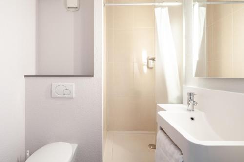 勒布尔热B&B HOTEL Paris Le Bourget的白色的浴室设有水槽和卫生间。