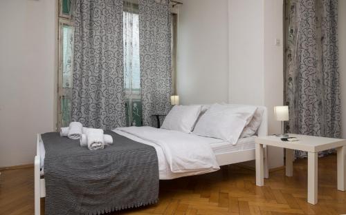 乌日策Apartman Panorama Glavna ulica的一间小卧室,配有一张床和一张桌子