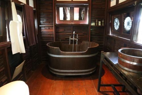 Tha Lane BayLe Passe-Temps的木制浴室设有浴缸和水槽