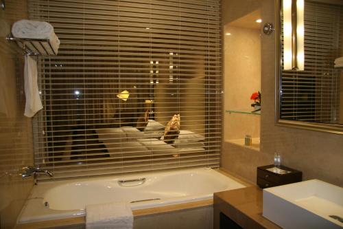 北京北京日坛宾馆的带浴缸、窗户和水槽的浴室