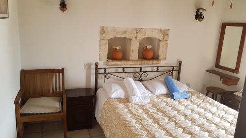 卡西卡斯米哈利斯阿诺雅传统石屋乡村民宿的一间卧室配有一张床,上面有两条毛巾