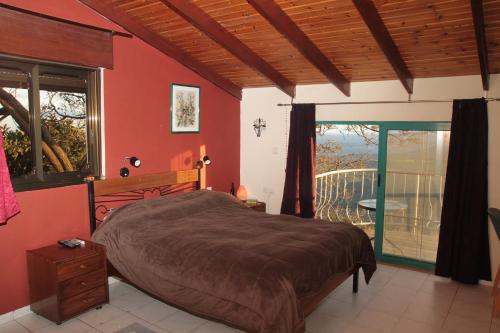 埃米瑞姆Switzerland In Amirim的一间带大床的卧室和一个阳台