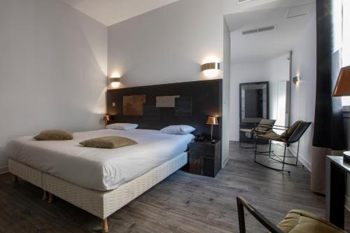 塞特港巴黎酒店的一间卧室配有一张大床和一张书桌