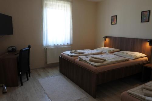 大梅杰尔Aquasleep的一间卧室设有两张单人床和一个窗户。