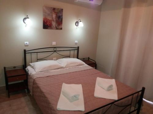 阿尔米罗斯海滩Villa Katerina Almyros的一间卧室配有一张带两条白色毛巾的床