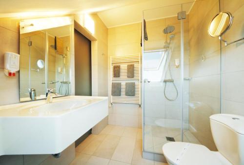 布尔沙伊德圣费亚科酒店的带浴缸、淋浴和盥洗盆的浴室