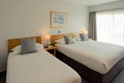 沃特福德沃特福德维京酒店的配有窗户的酒店客房内的两张床
