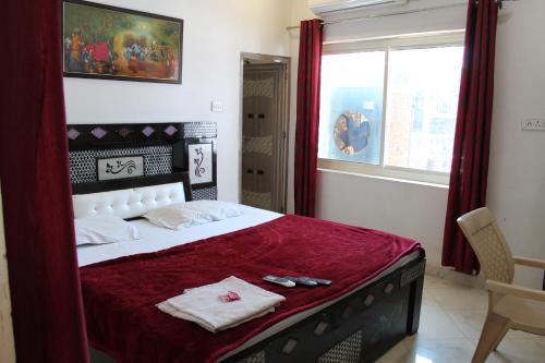 奥拉奇哈日落酒店的一间卧室配有一张带红色毯子的大床