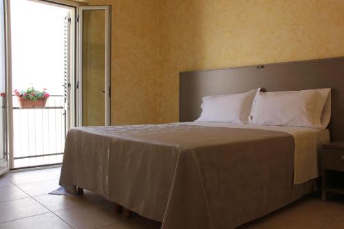 贝尔纳尔达B&B Casa Venezia的一间卧室设有一张大床和大窗户