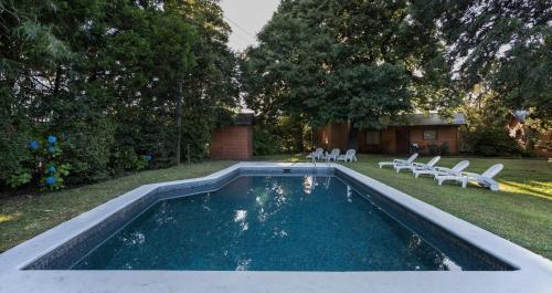 普孔玛普莱山林小屋的一个带椅子的庭院和房子的游泳池
