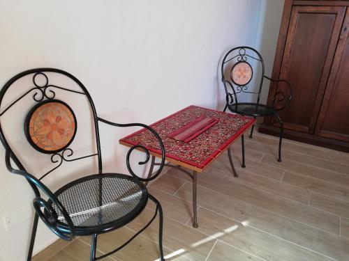 渥尔特拉Casa Mosaico的两把椅子和一张桌子以及一张桌子和椅子