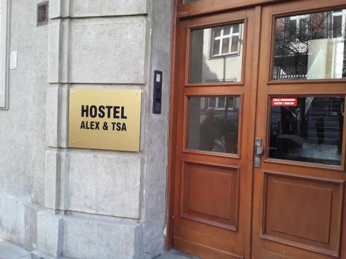 克拉科夫Hostel ALEX&TSA的门旁建筑物的一侧的标志